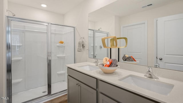 bathroom featuring vanity and an enclosed shower