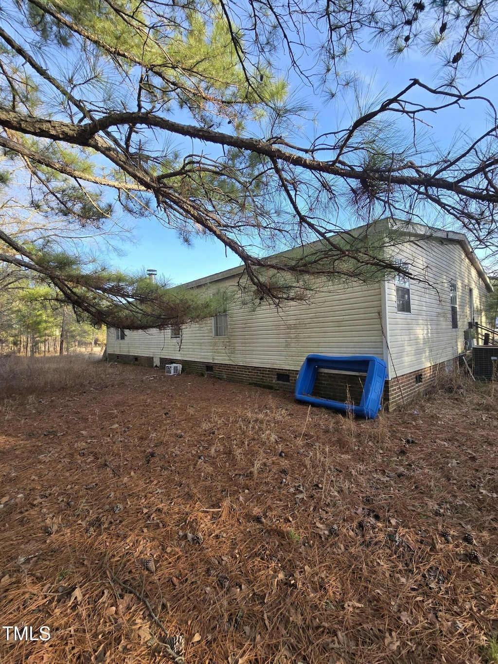 view of side of property with central AC