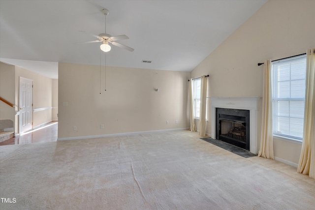 unfurnished living room featuring high vaulted ceiling, light carpet, and ceiling fan