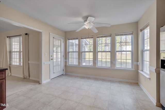 unfurnished sunroom with plenty of natural light and ceiling fan