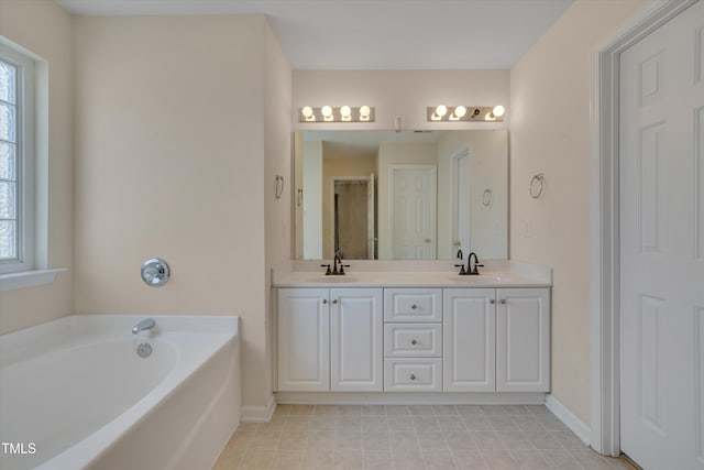 bathroom with vanity, a bathtub, and a wealth of natural light