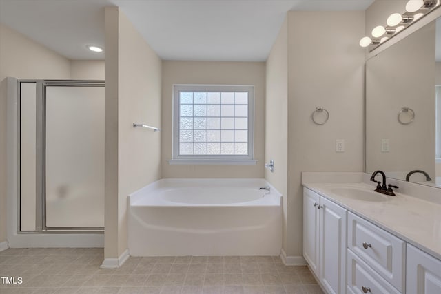 bathroom featuring vanity and independent shower and bath