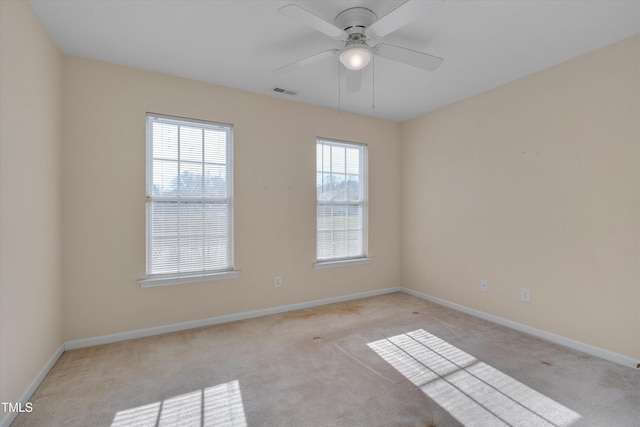 unfurnished room with light carpet and ceiling fan