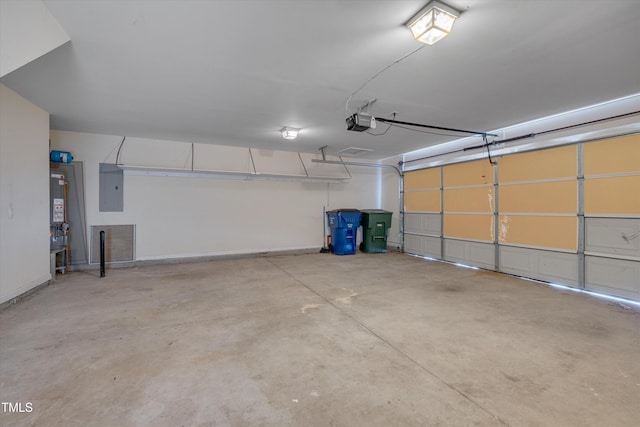 garage featuring a garage door opener, gas water heater, and electric panel