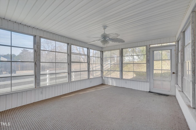 unfurnished sunroom featuring ceiling fan