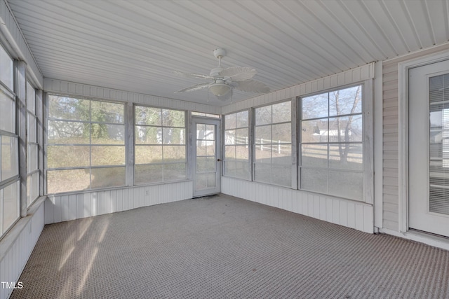 unfurnished sunroom featuring ceiling fan