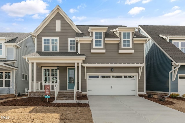 view of front of house featuring covered porch, driveway, an attached garage, and a shingled roof