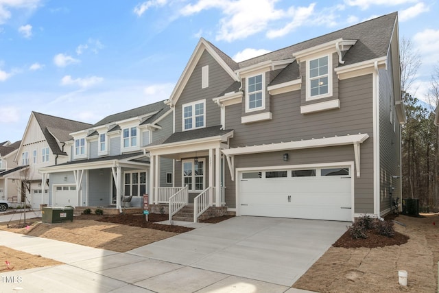 view of front of property with a shingled roof, concrete driveway, central AC, covered porch, and an attached garage