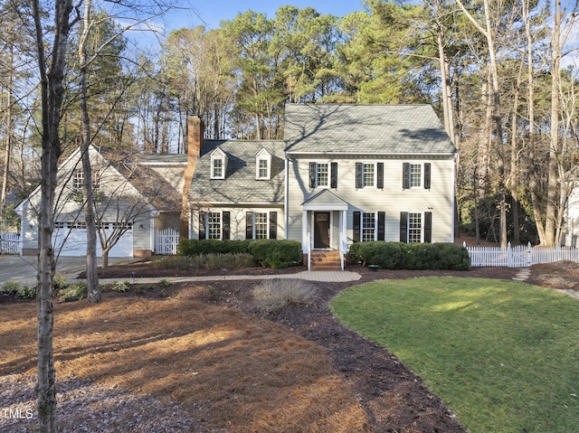 view of front of home featuring a chimney, a front yard, and fence