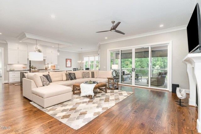 living area featuring recessed lighting, ornamental molding, ceiling fan, and wood finished floors