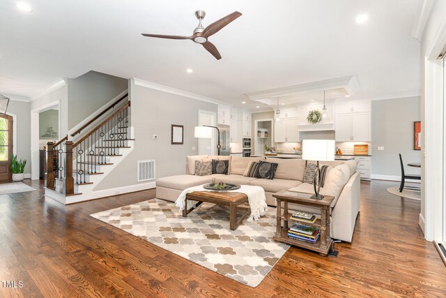 living area featuring a ceiling fan, visible vents, crown molding, stairs, and recessed lighting