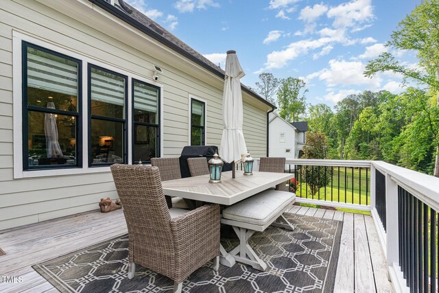 deck with outdoor dining area