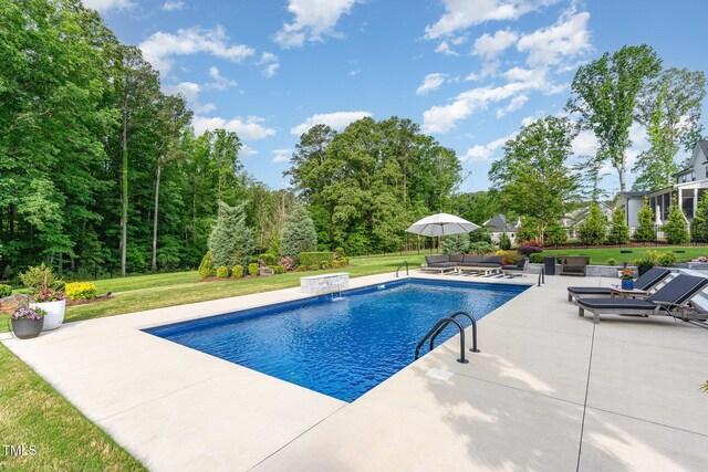 pool with a patio, a yard, and an outdoor hangout area