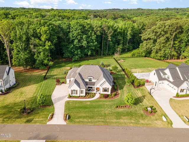 drone / aerial view featuring a wooded view