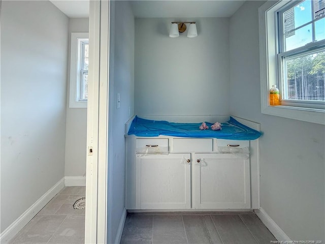 bathroom with baseboards and a wealth of natural light