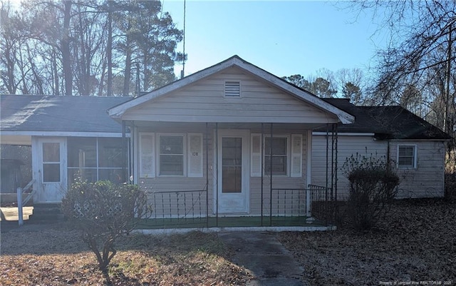 view of front of home with a porch and a sunroom