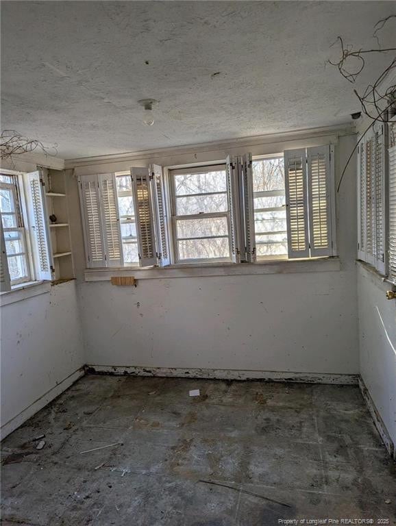 spare room with a textured ceiling