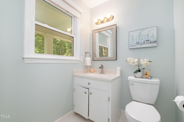 half bathroom with toilet, baseboards, and vanity