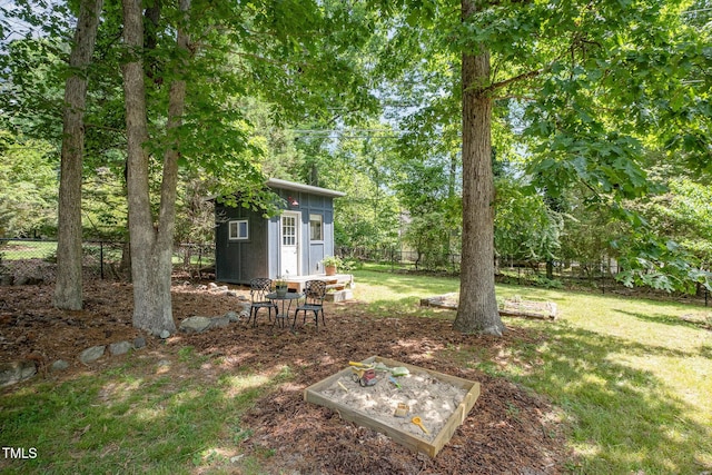 view of yard featuring an outdoor structure, fence private yard, and a shed