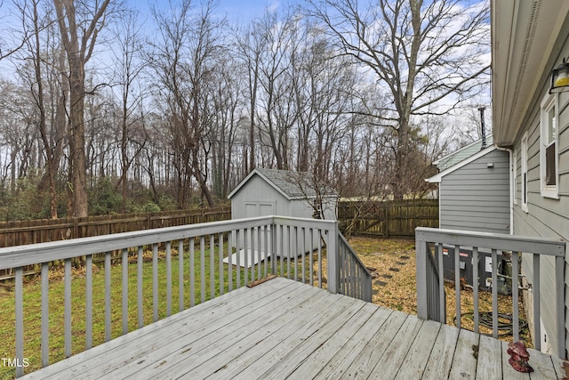 wooden terrace featuring a storage shed and a yard