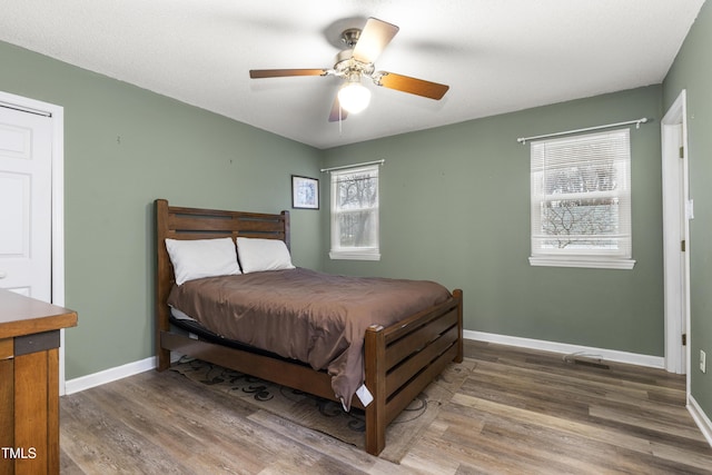 bedroom featuring hardwood / wood-style flooring and ceiling fan