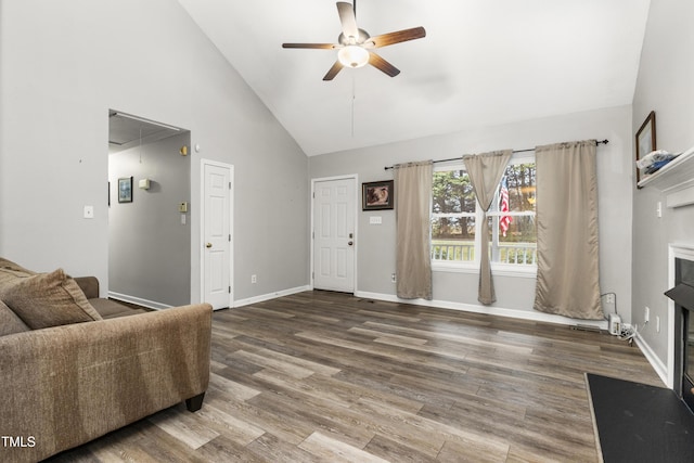 living room featuring hardwood / wood-style flooring, ceiling fan, and high vaulted ceiling