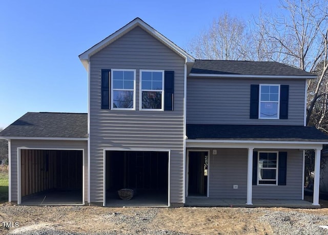 view of front property featuring a garage and covered porch