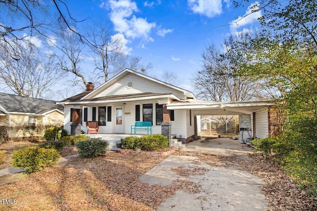 view of front of home featuring a carport and covered porch