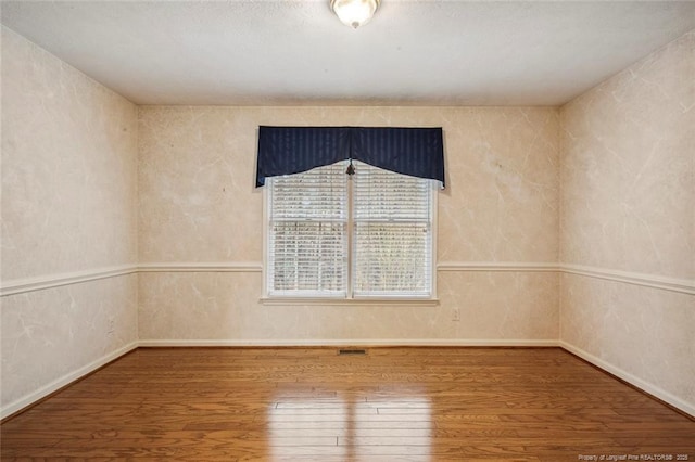 spare room featuring hardwood / wood-style flooring