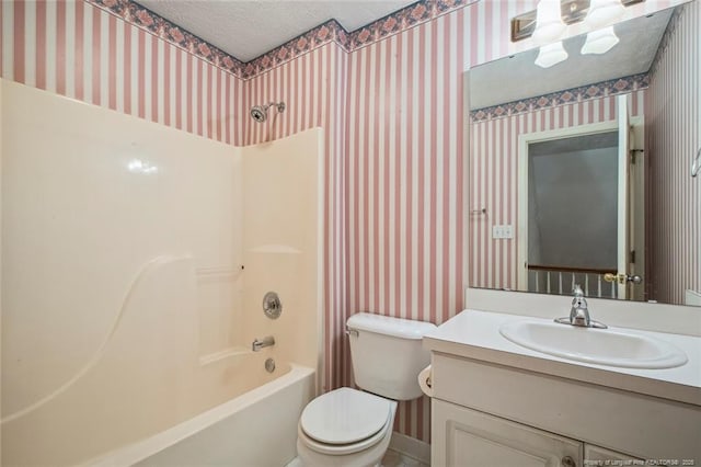 full bathroom featuring vanity, toilet, tub / shower combination, and a textured ceiling