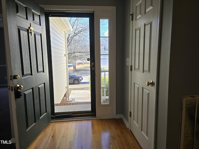 entryway featuring wood finished floors and visible vents