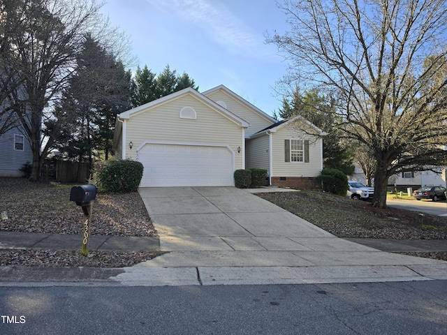 view of front of house with concrete driveway, crawl space, and an attached garage