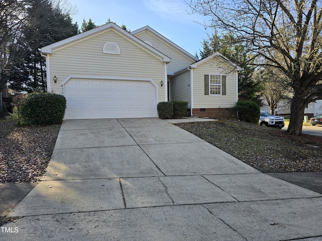 ranch-style home featuring an attached garage and concrete driveway