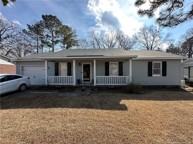 single story home featuring a garage, a front lawn, and a porch