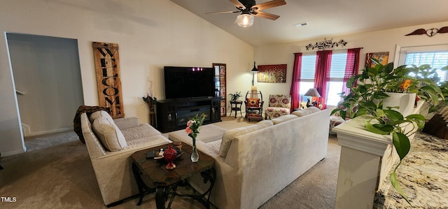 living room featuring lofted ceiling, ceiling fan, a healthy amount of sunlight, and carpet