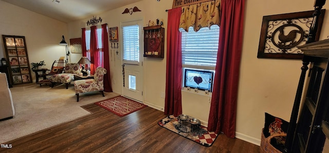 foyer entrance with dark wood-type flooring and lofted ceiling