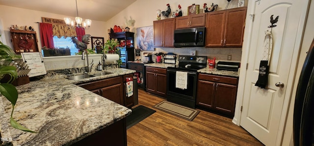 kitchen featuring pendant lighting, sink, backsplash, black electric range, and dark hardwood / wood-style flooring