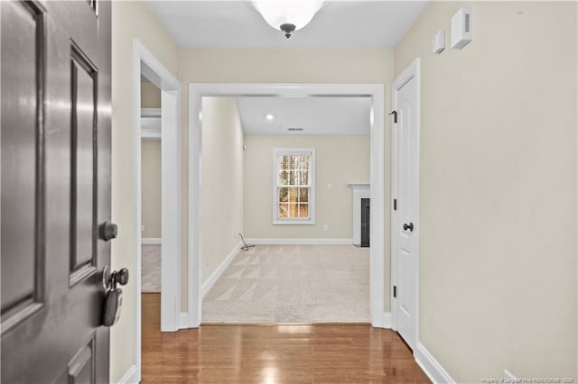 corridor featuring hardwood / wood-style floors