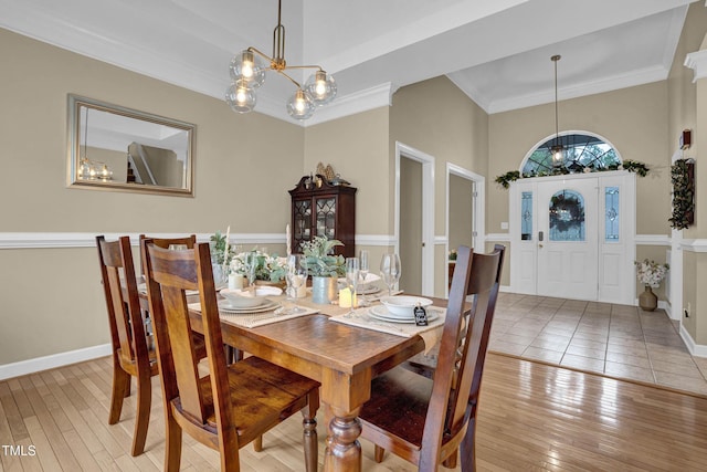 dining space featuring crown molding, a notable chandelier, and light hardwood / wood-style floors