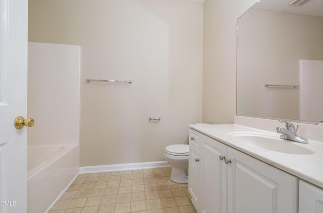 bathroom featuring vanity, a bathtub, and toilet