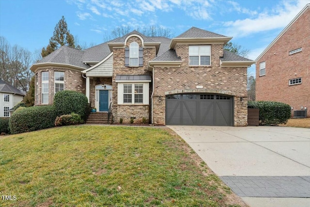 view of front of home featuring a garage, central AC, and a front lawn