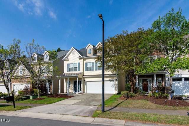 104 Mainline Station Dr, Durham, NC 27560 - view of front facade with a standing seam roof, concrete driveway, a garage, and a metal roof