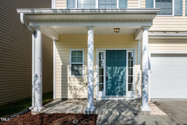 104 Mainline Station Dr, Durham, NC 27560 - doorway to property with a garage and covered porch
