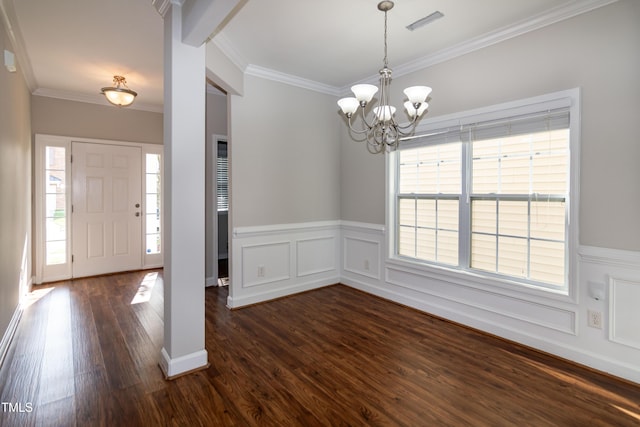 104 Mainline Station Dr, Durham, NC 27560 - foyer entrance with a chandelier, plenty of natural light, dark wood-style flooring, ornamental molding, and a wainscoted wall