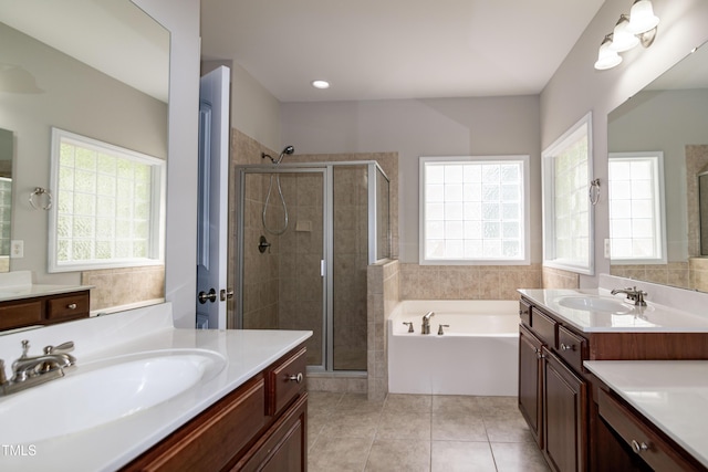 104 Mainline Station Dr, Durham, NC 27560 - bathroom with two vanities, a bath, a shower stall, and tile patterned floors