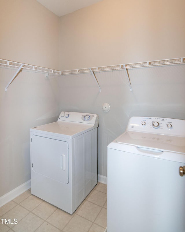 104 Mainline Station Dr, Durham, NC 27560 - washroom with washing machine and clothes dryer and light tile patterned floors