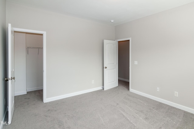 104 Mainline Station Dr, Durham, NC 27560 - unfurnished bedroom with a walk in closet, carpet flooring, and a closet