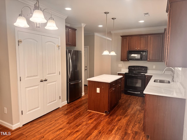 104 Mainline Station Dr, Durham, NC 27560 - kitchen featuring black appliances, dark wood-style flooring, a center island, ornamental molding, and pendant lighting
