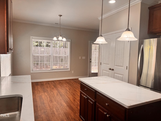 104 Mainline Station Dr, Durham, NC 27560 - kitchen with freestanding refrigerator, a chandelier, dark wood-type flooring, crown molding, and a kitchen island