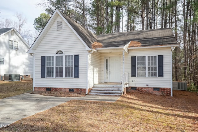 view of front of house with a front lawn and central air condition unit